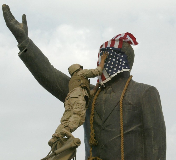 A US Marine covers a statue of Iraqi President Saddam Hussein with the US flag in Baghdad’s al-Fardous square in April 2003, before the statue was toppled. EPA PHOTO AFPI/RAMZI HAIDAR A US Marine covers a statue of Iraqi President Saddam Hussein with the US flag in Baghdad’s al-Fardous square in April 2003, before the statue was toppled. EPA PHOTO AFPI/RAMZI HAIDAR