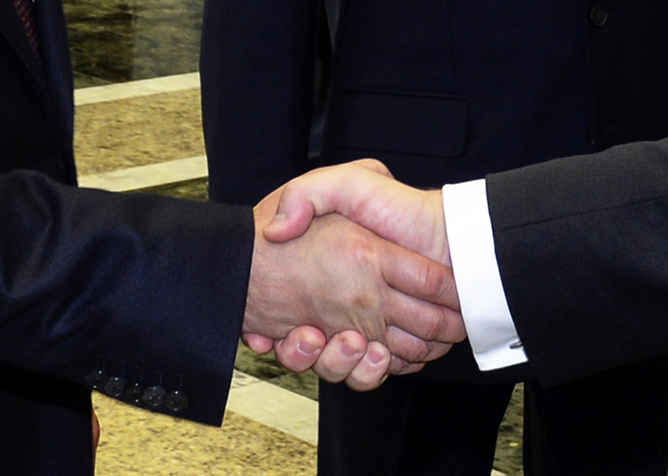 Peace in our time? Poroshenko and Putin shake hands in Minsk. EPA/Sergei Bondarenko Peace in our time? Poroshenko and Putin shake hands in Minsk. EPA/Sergei Bondarenko