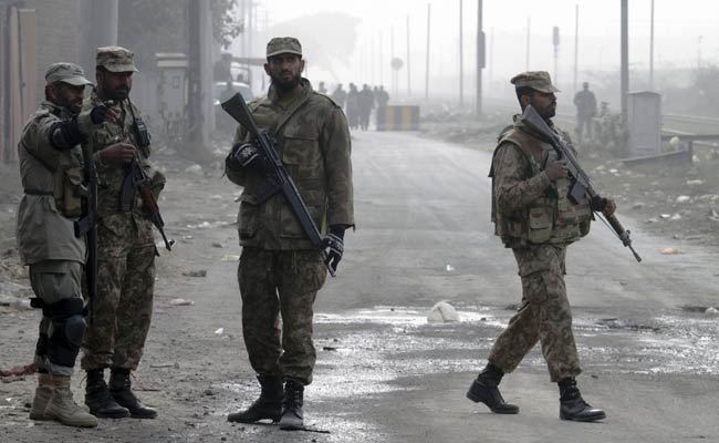 Pakistan Army troops stand guard at a road leading to the central prison on the outskirts of Lahore. (Associated Press) Pakistan Army troops stand guard at a road leading to the central prison on the outskirts of Lahore. (Associated Press)